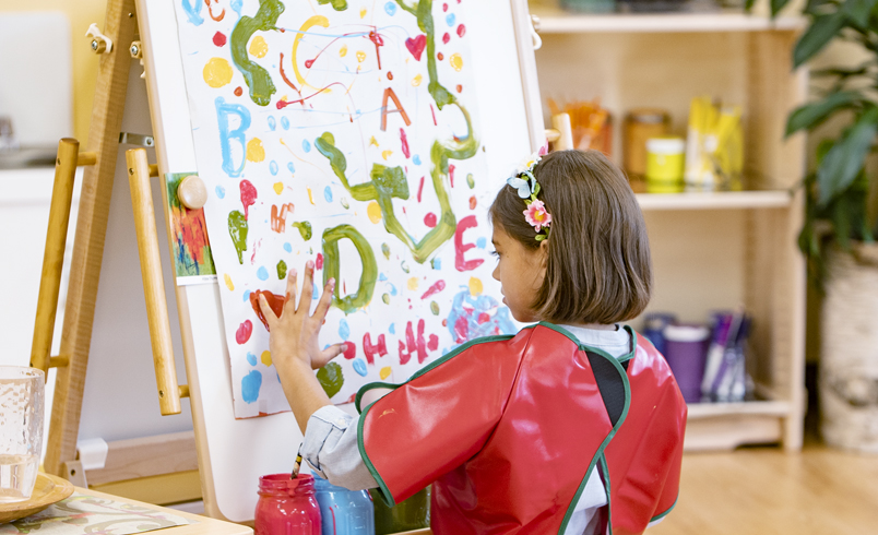 Child painting at Mini Art Island