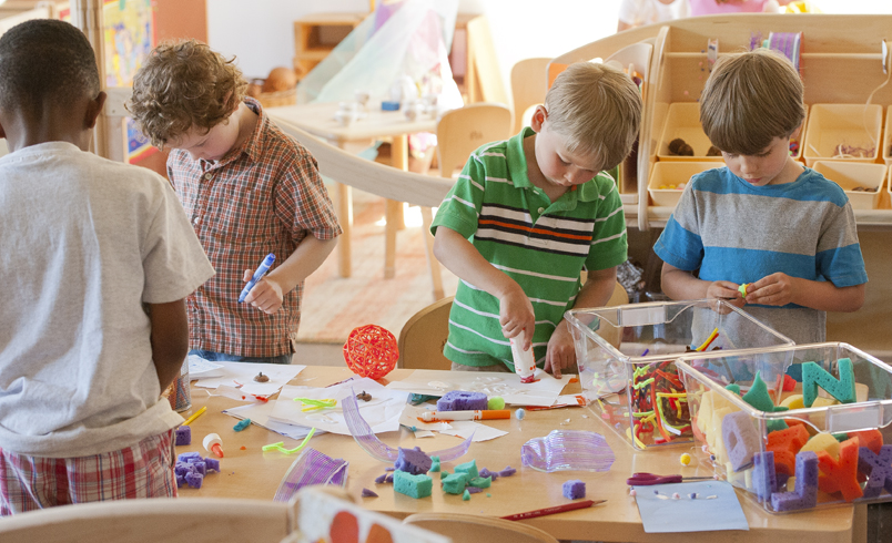 Children doing arts and crafts at Classroom Activity table