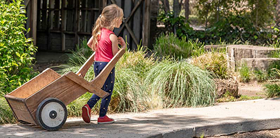 Girl pulling Outlast wheelbarrow