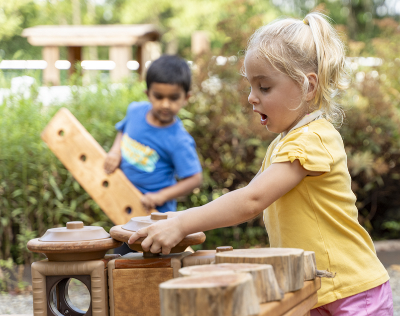 Two children playing with Outlast blocks