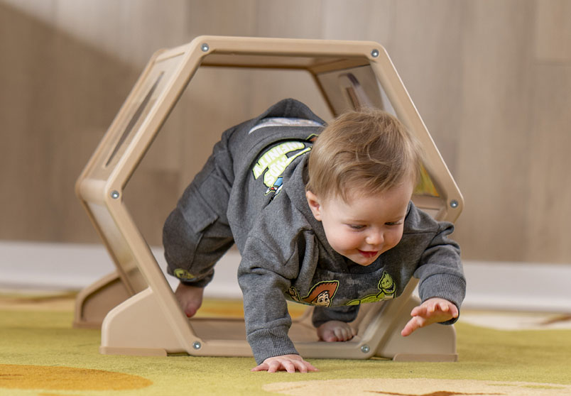 Child crawling through Toddler Tunnel