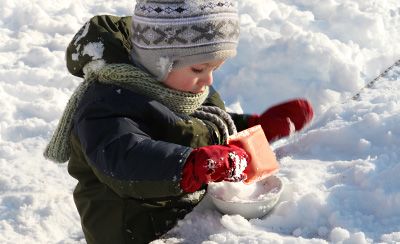 Toddler playing in snow