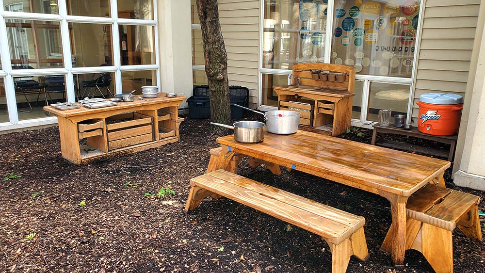 Outlast table and benches, with Mud Kitchen nearby