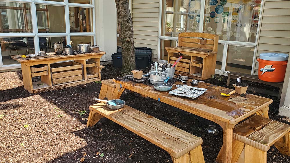 Outlast Mud Kitchen area with accessories all set out for the children