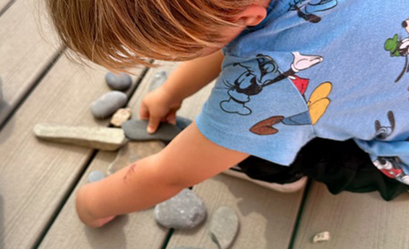 Child playing with stones
