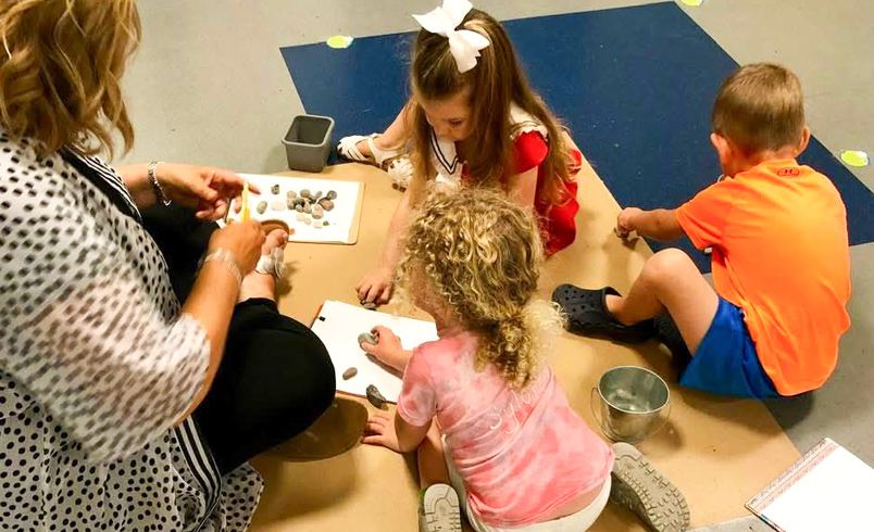 Children playing with stones indoors
