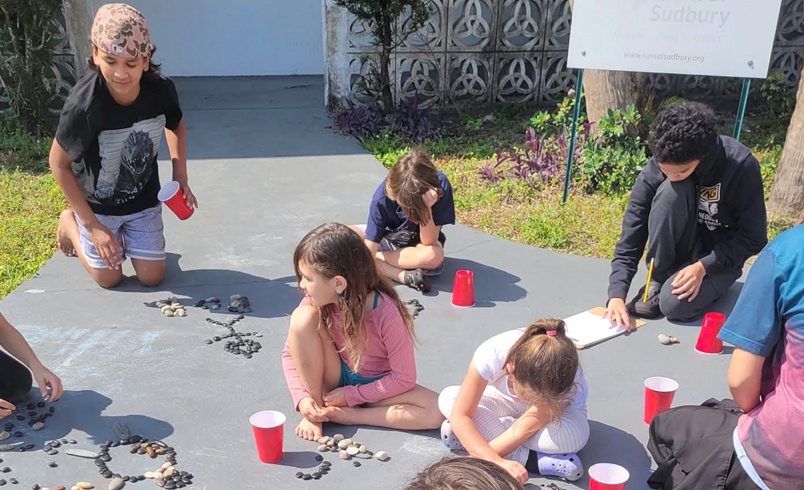 Children laying stones out in groups