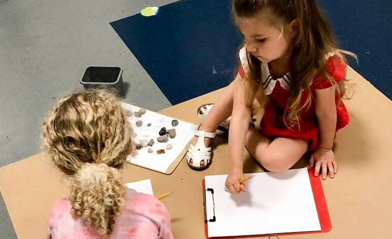 children storytelling with stones