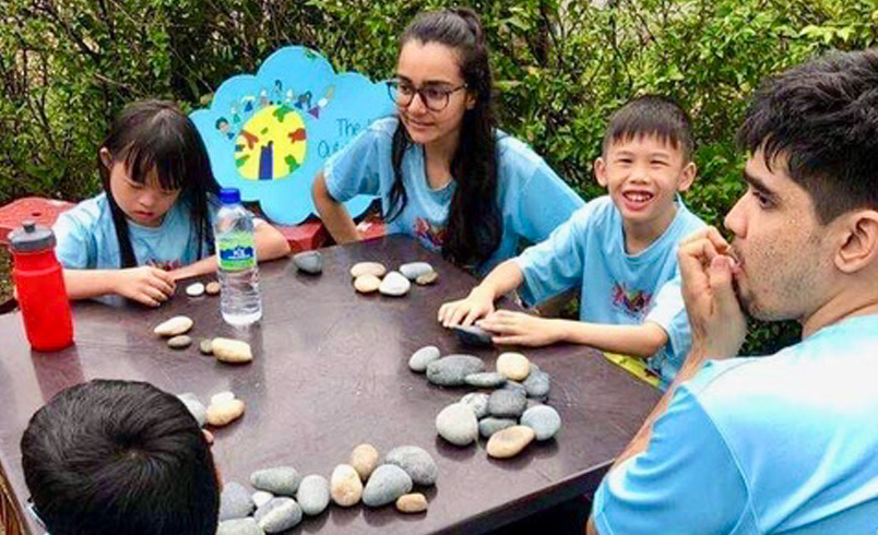 Special needs children doing stonework play