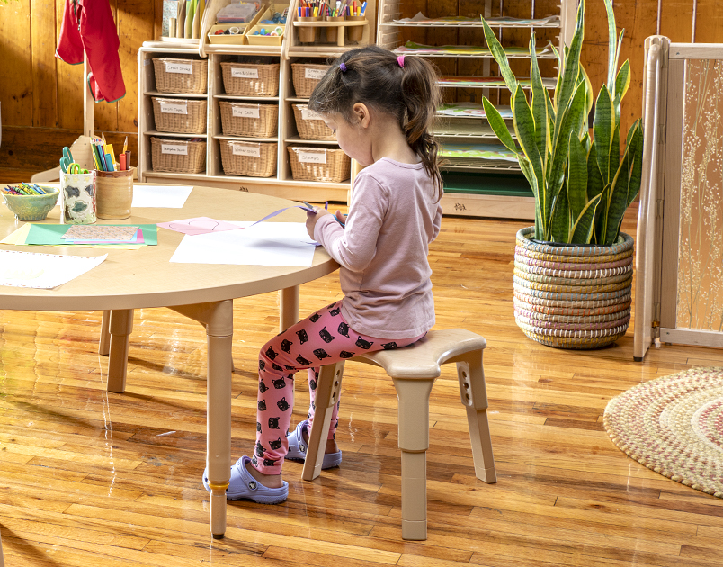 Child seated on a Grow-Right stool