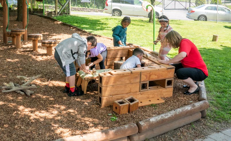 Children and teacher stacking Outlast blocks