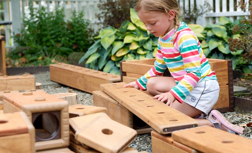 child stacking Outlast plank onto structure