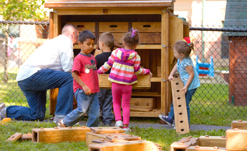 Children and staff member packing away Outlast blocks
