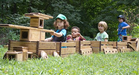 children in a train made of crates