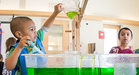 child playing with colored water