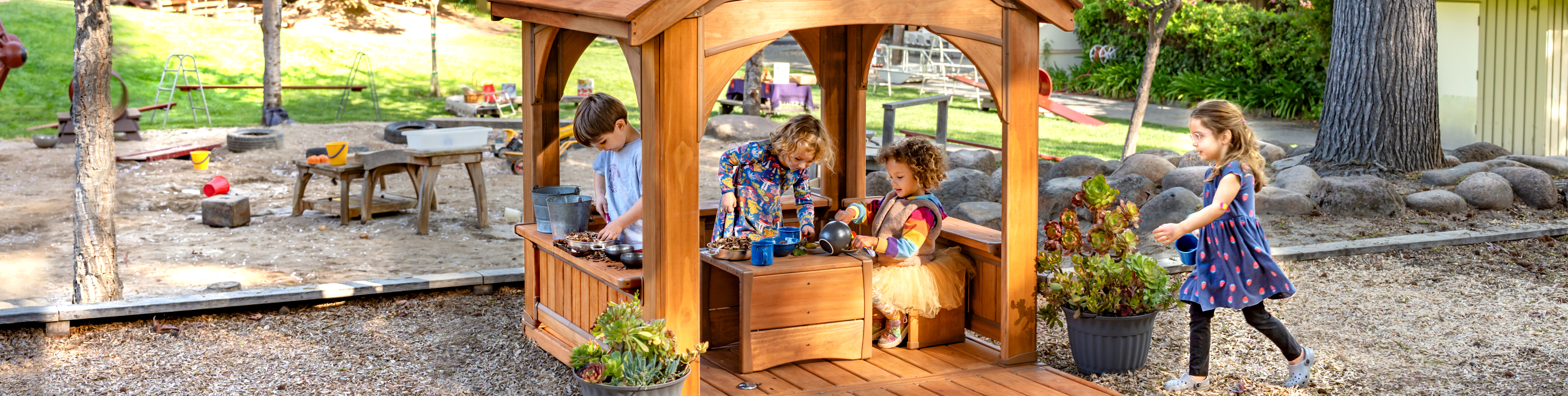 Preschool kids in a playhouse outdoors