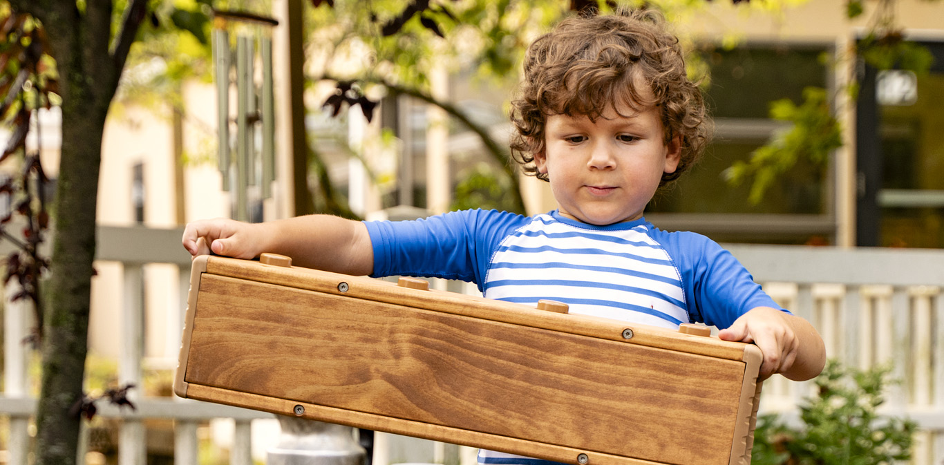 A child playing with an Outlast block