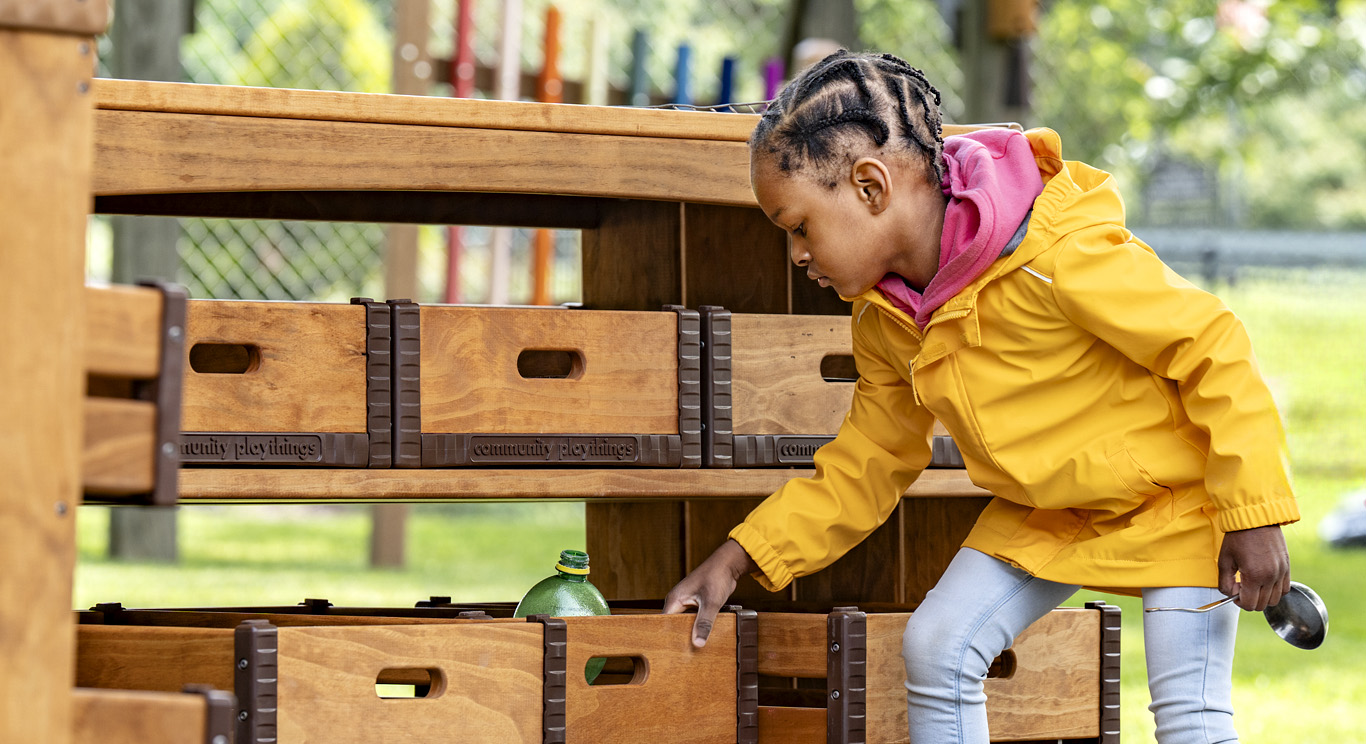 A child pulling an Outlast crate off a shelf