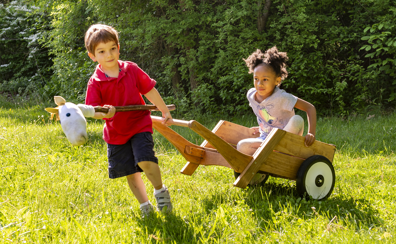 Children playing with an Outlast Wheelbarrow