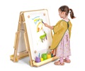 A child painting at a floor easel