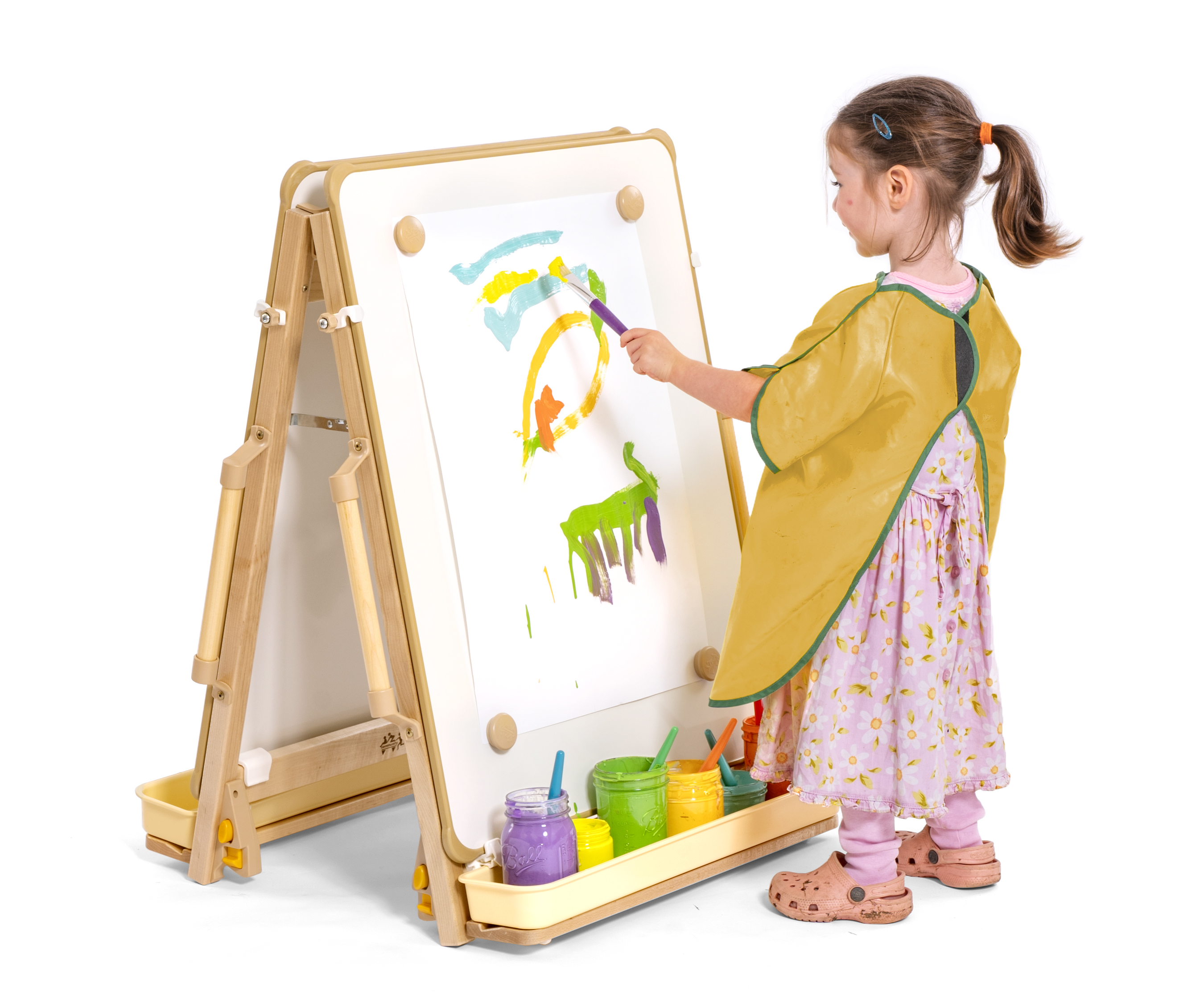 A child painting at a floor easel