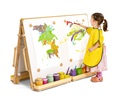 Girl with yellow apron painting at a floor easel
