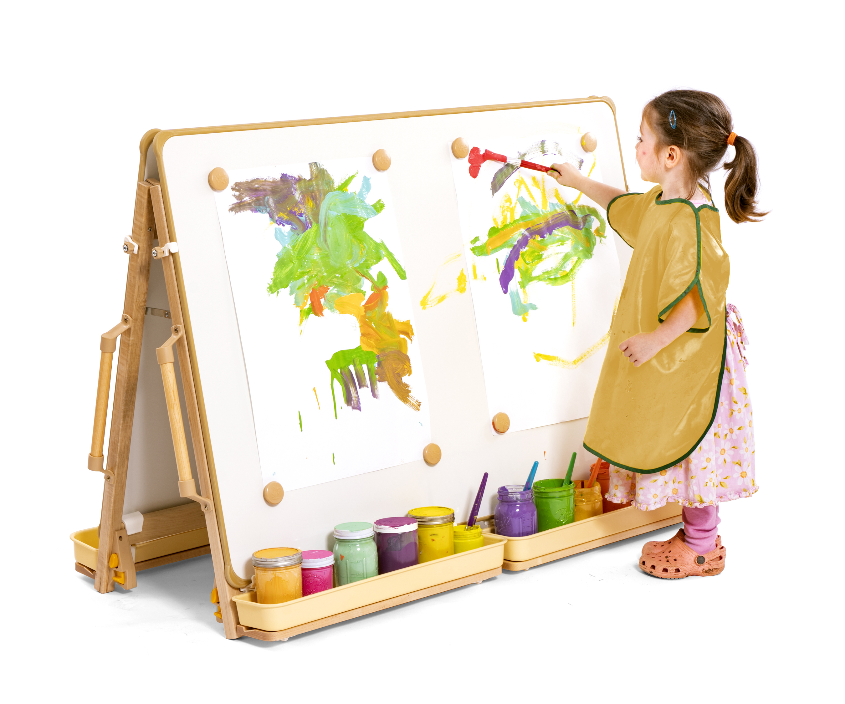 Girl with yellow apron painting at a floor easel