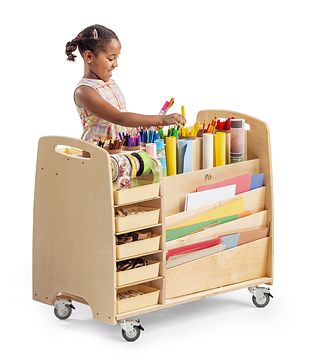 A child taking art material from a Help Yourself Trolley