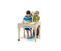 Two children playing at a small indoor sand and water table