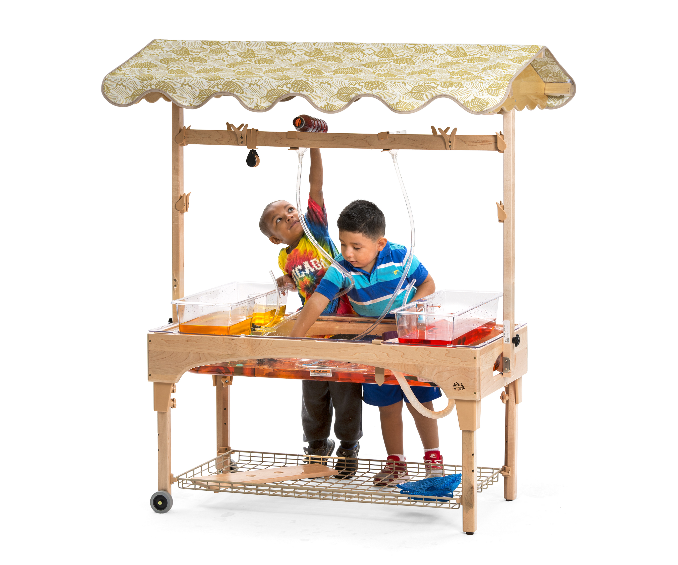 Two children playing at a large sand and water center