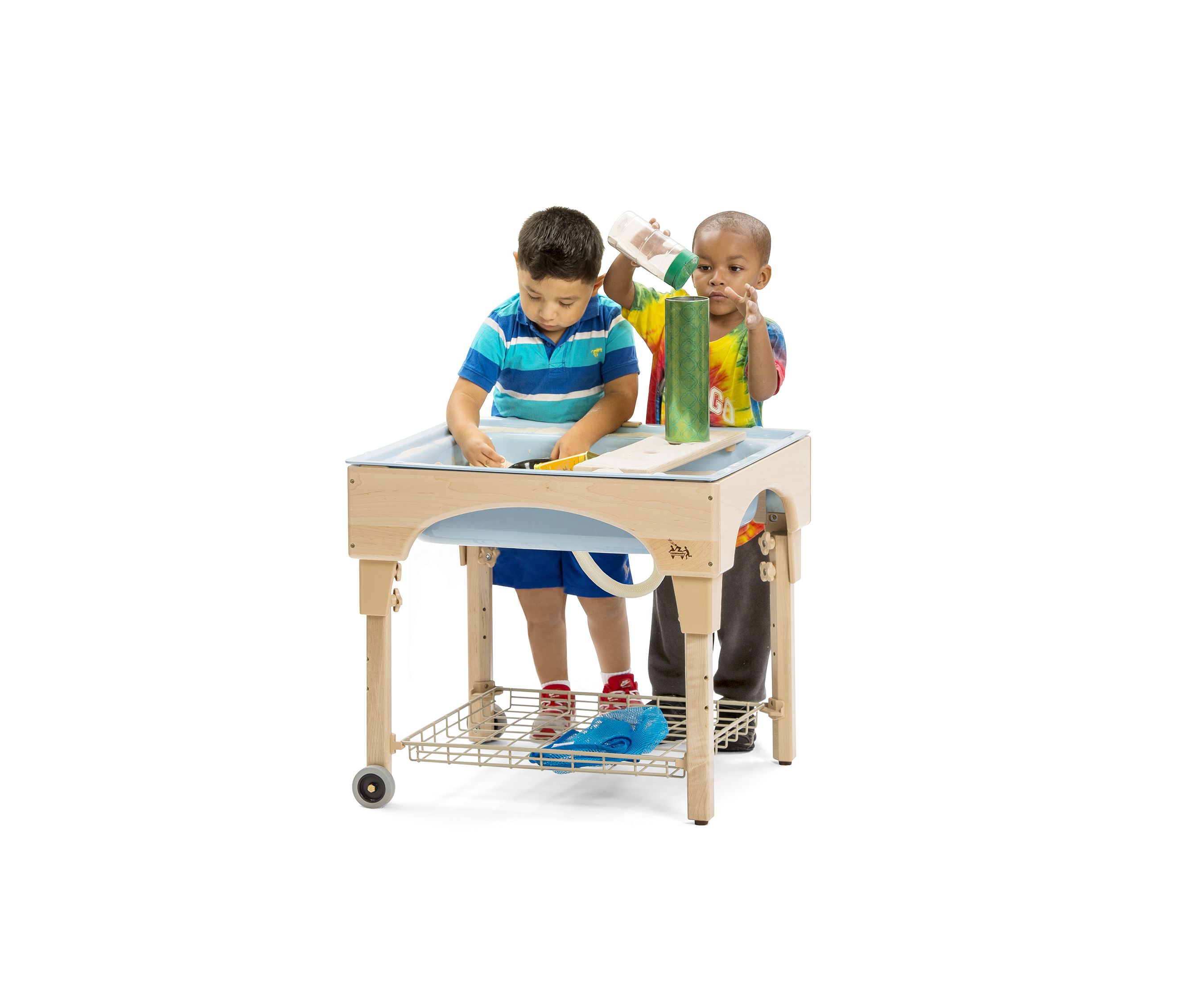 Two children playing at a small indoor sand and water table