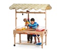 Two children playing at a large sand and water center