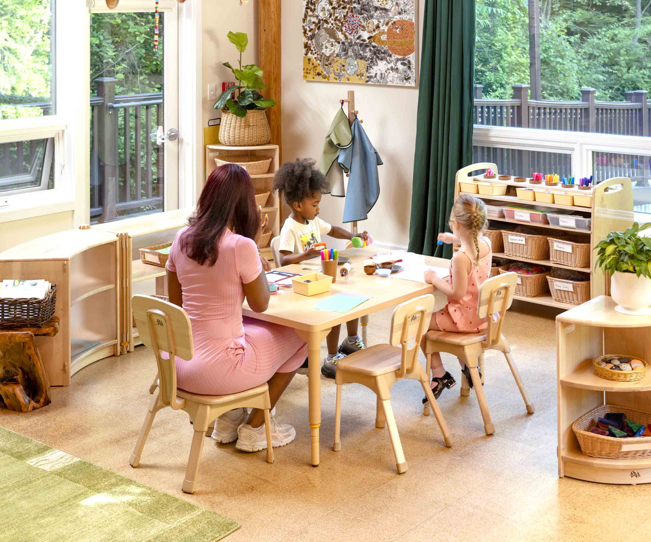 Teacher seated at table with chidlren on Teacher Classroom Chair