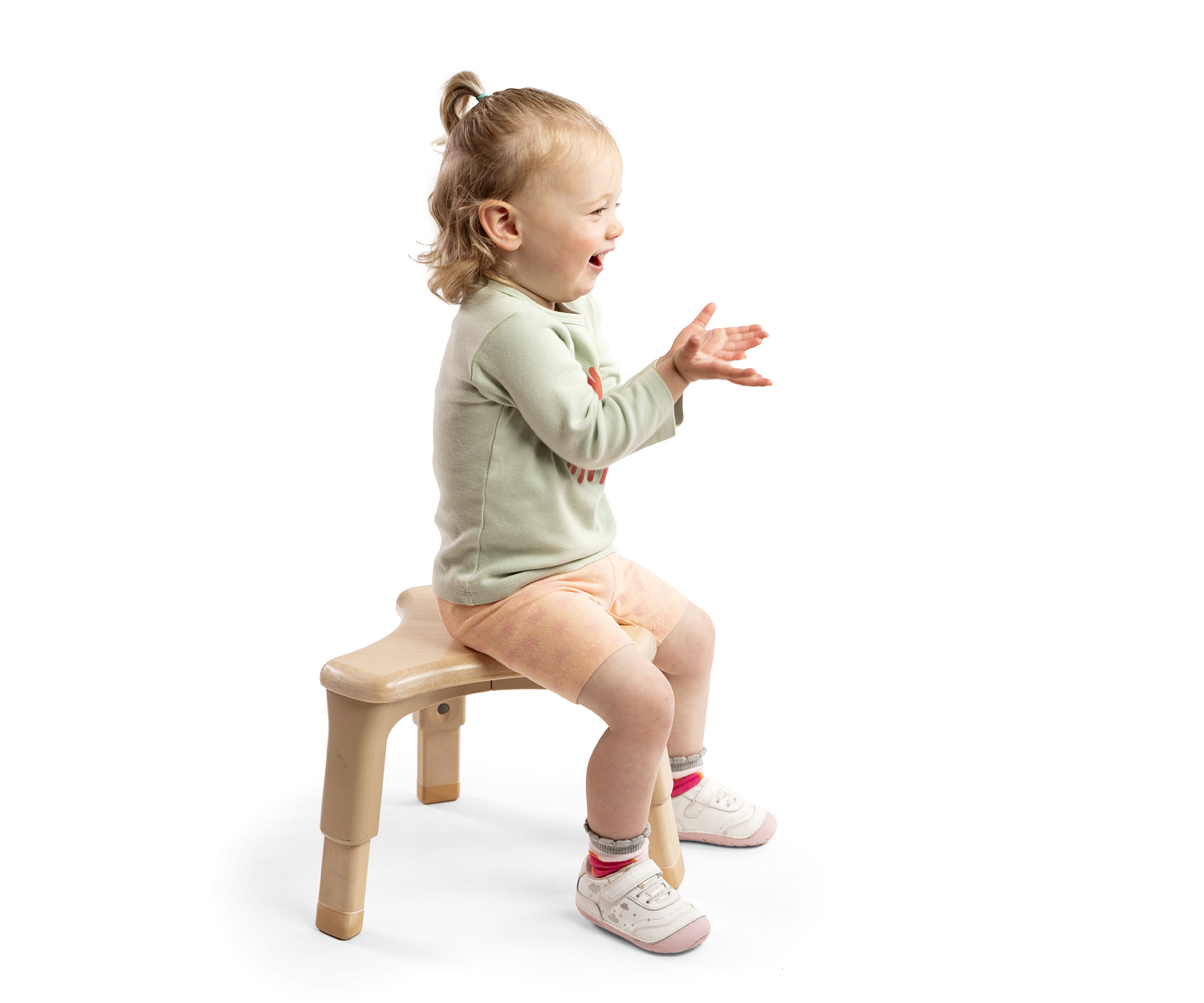Toddler girl sitting on grow-right stool