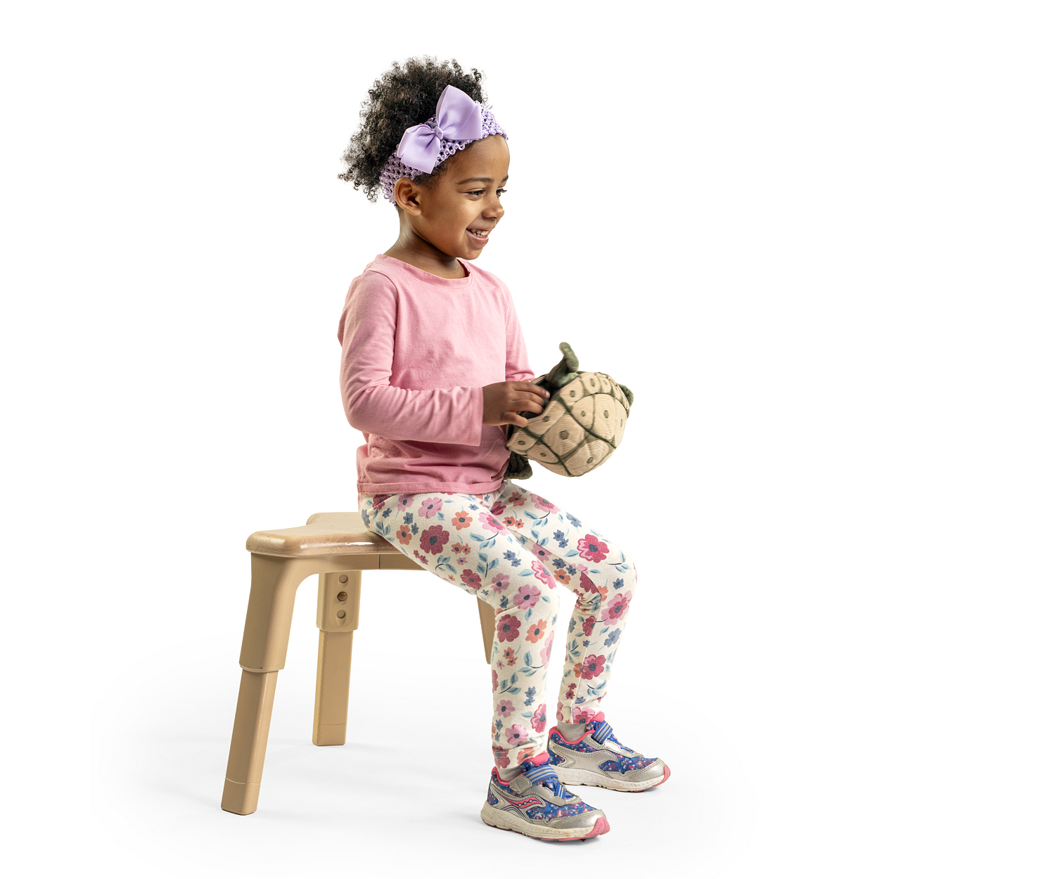 Preschool girl sitting on grow-right stool