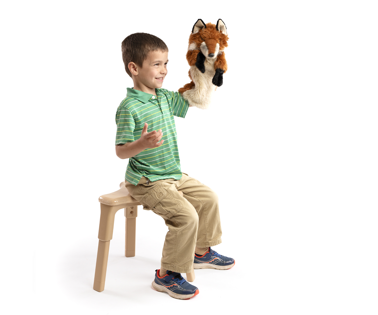 Preschool boy sitting on grow-right stool