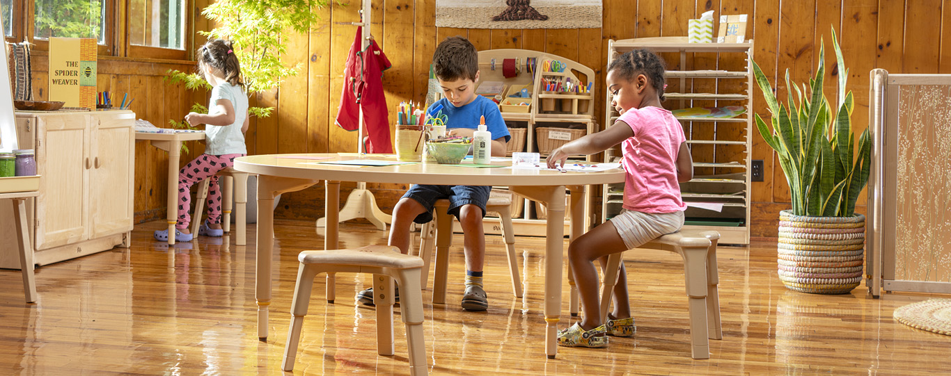 Preschool kids sitting on ergonomic stools for art project