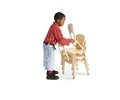 A boy is stacking classroom chairs