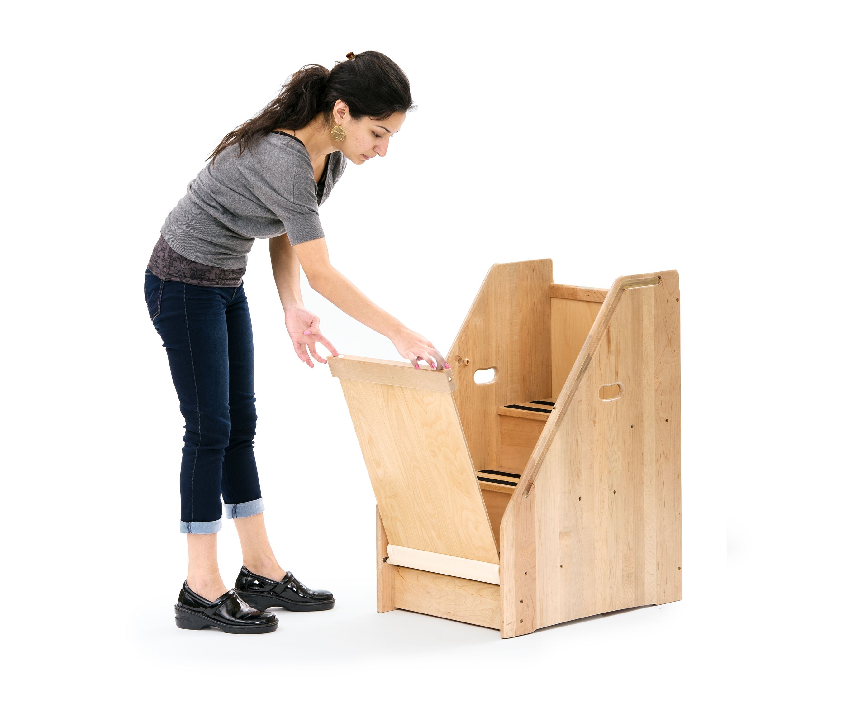 A woman is operating the cover of the Toddler Step Stool