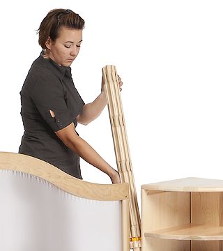 A woman is attaching a panel to a shelf using a Roomscapes post