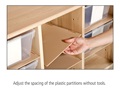 a hand demonstrating an adjustable shelf