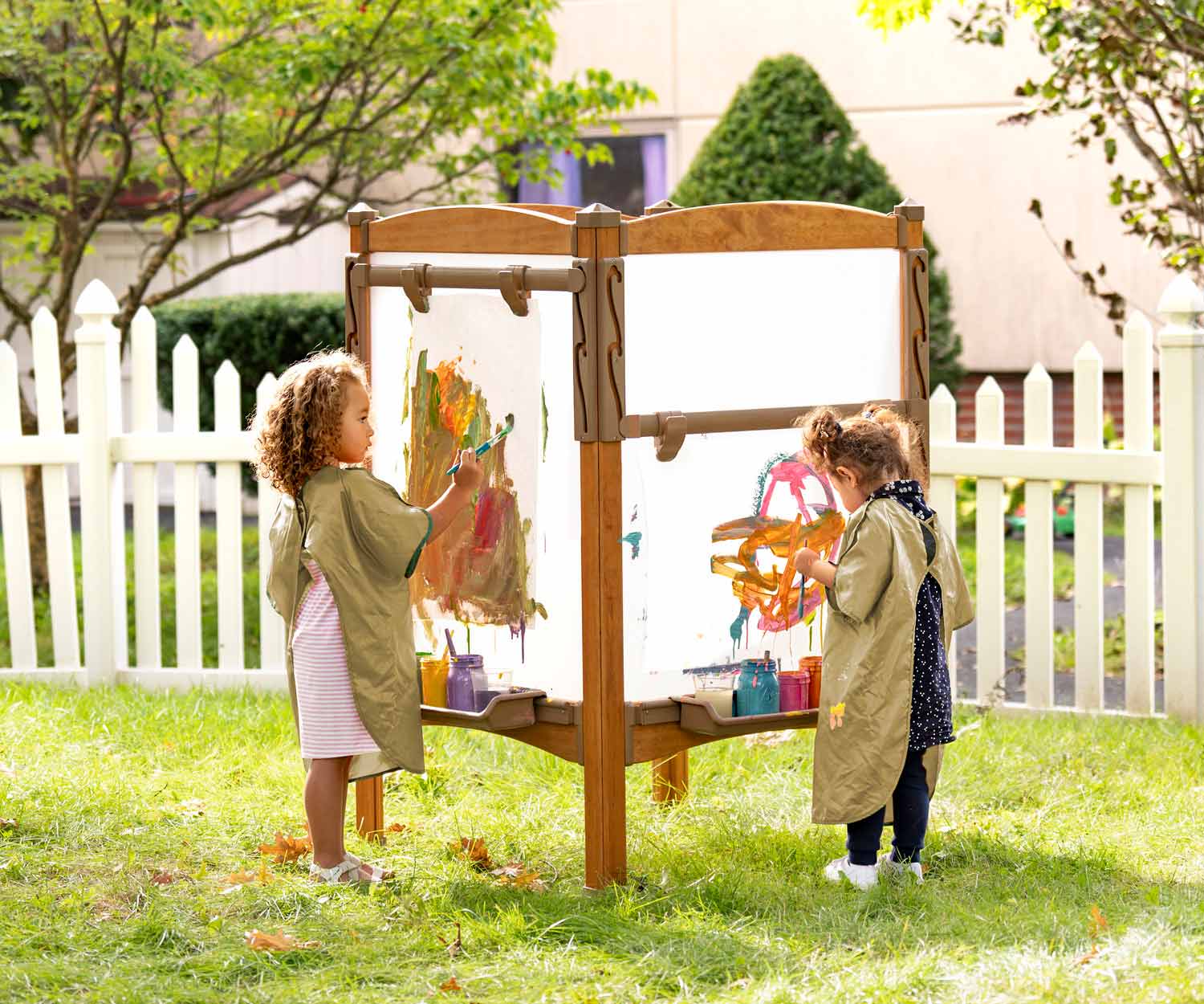 Children painting at Easel island outdoors