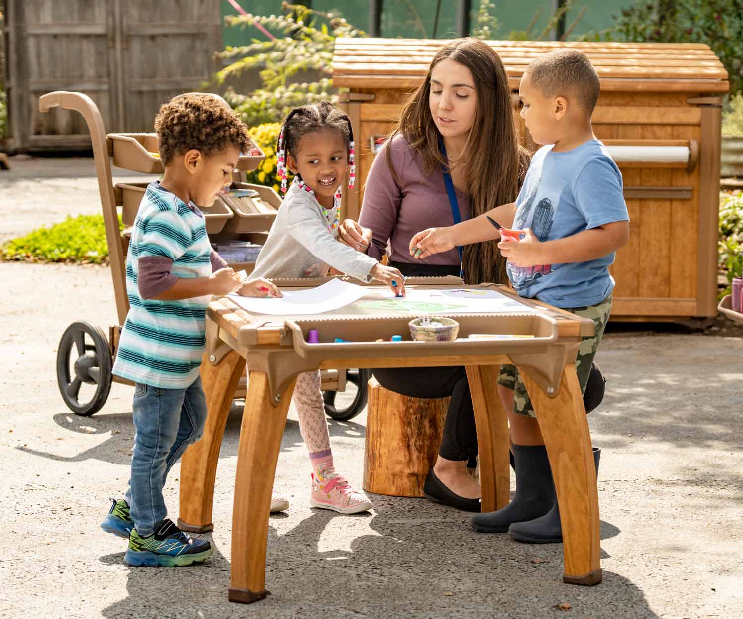 Children making art at small Outlast art table