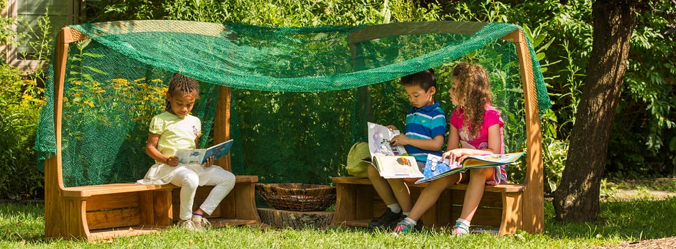 Children reading books under the Outlast Arbor