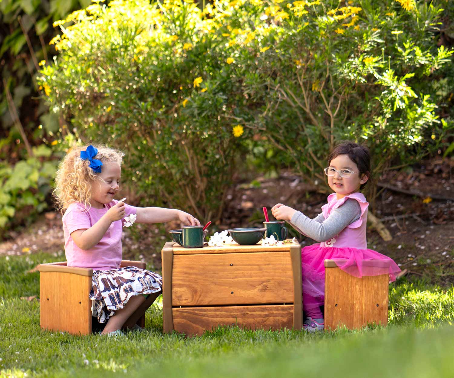 kids playing at table and chair set outdoors