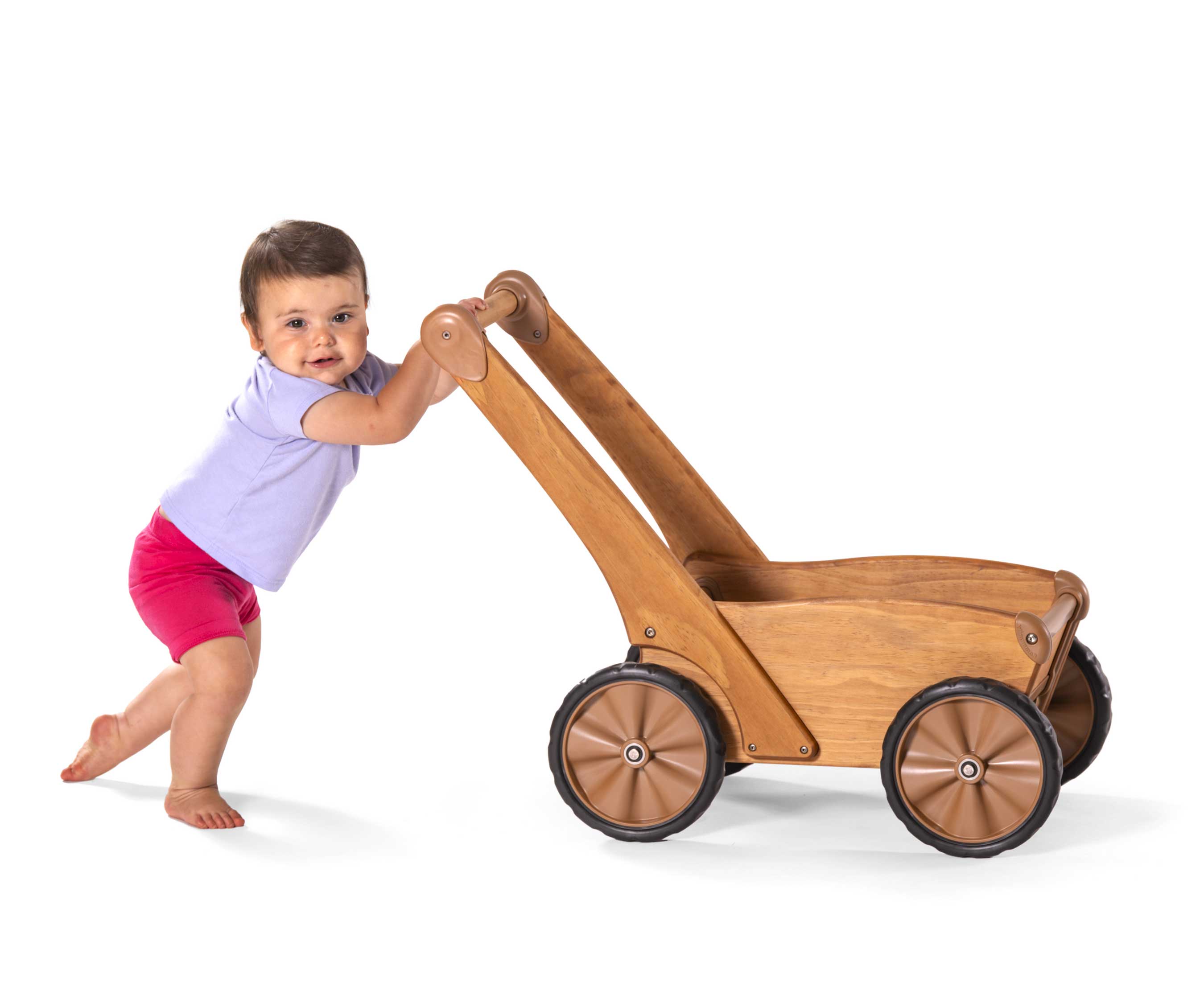 Child smiling at you while pulling to stand using Outlast Push Wagon