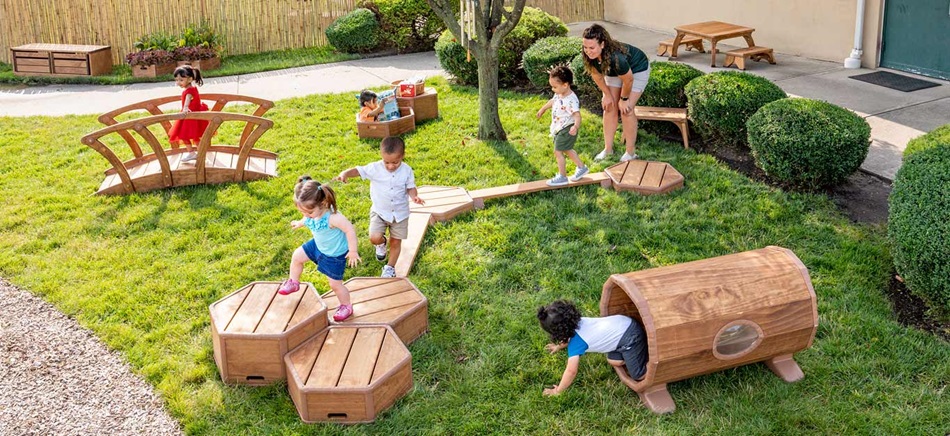 kids playing on toddler climbing toys outdoors