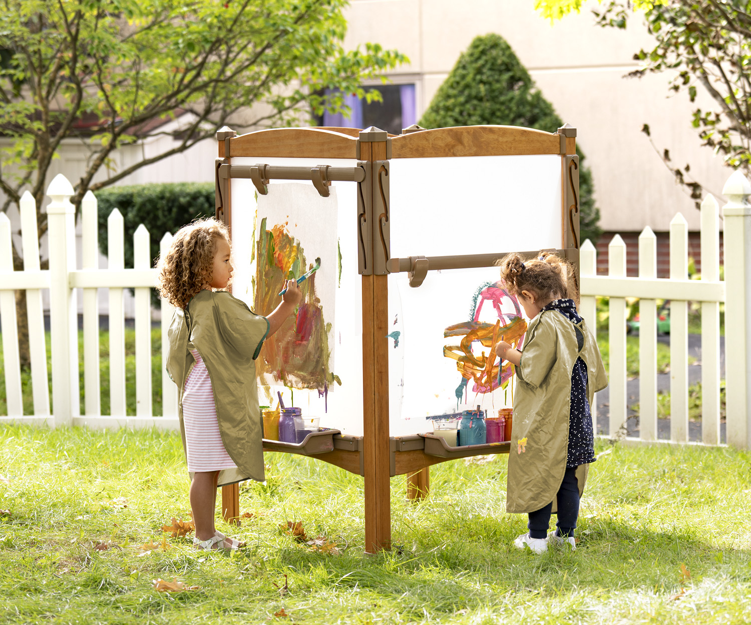 preschool kids painting on outdoor art easel
