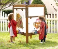preschool kids painting on outdoor art easel