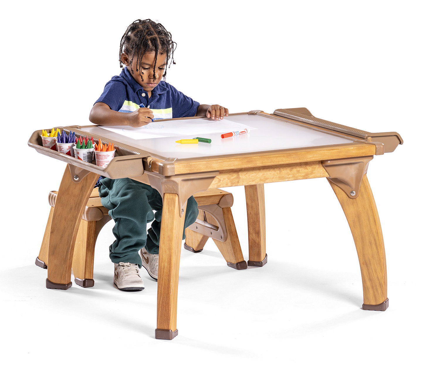 preschool boy working at outdoor art table